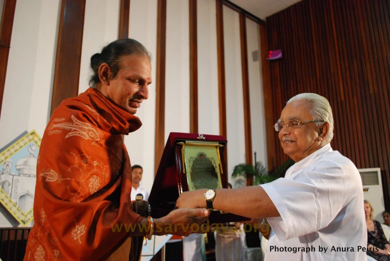 an elderly man is shaking an older gentleman's hand