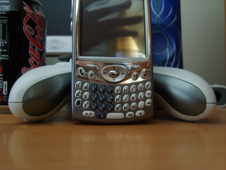 an older cell phone sitting in the middle of a desk