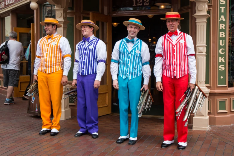 four men in colorful clothes are posing for a po