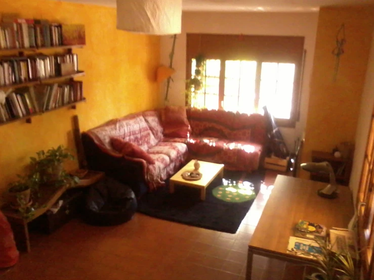 the living room has yellow walls and a red couch