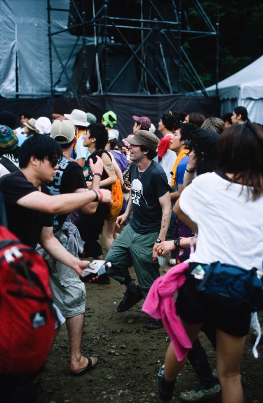 a crowd of people standing around near one another