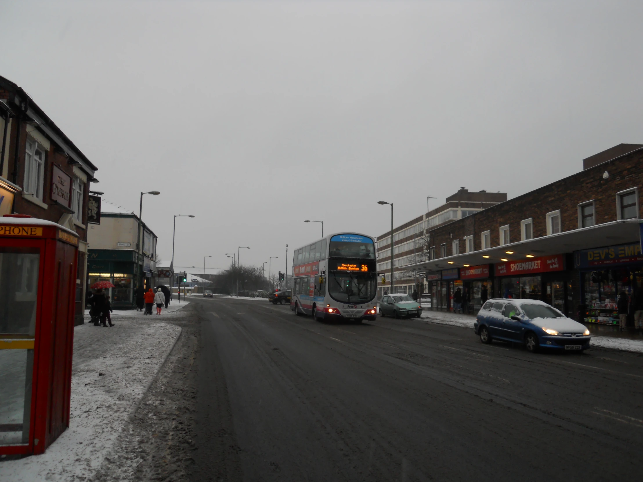 a busy street with cars on a snowy day