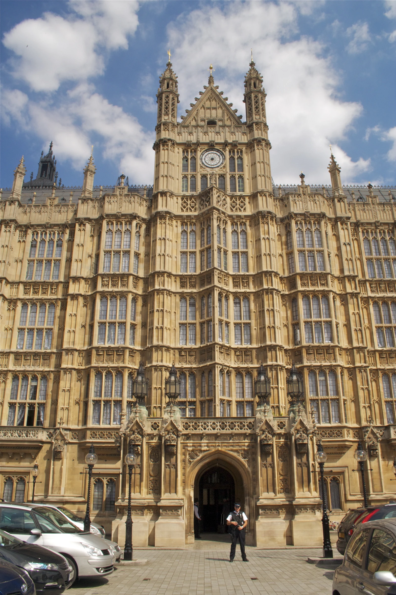 a large stone building with a massive clock on the front