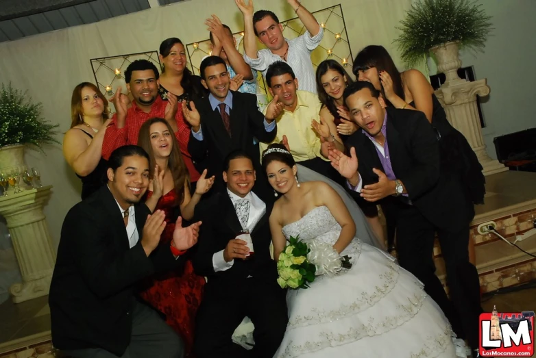 a bride and groom are giving their hand signs