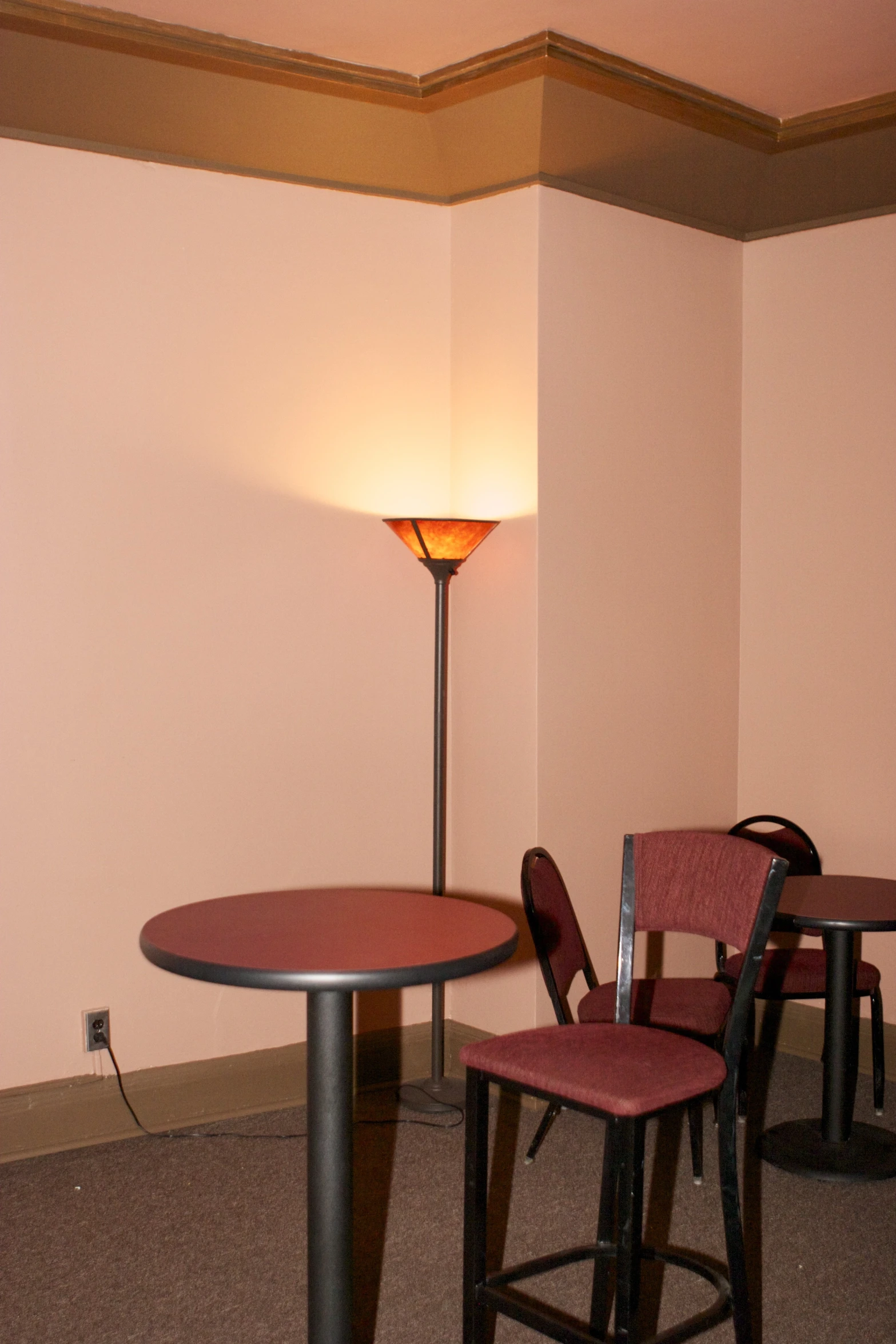 a room with some red chairs and black table