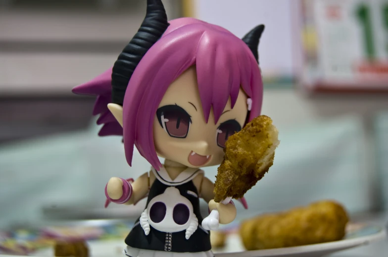 a doll with horns holding a piece of food