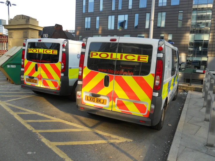 two city buses are parked next to each other