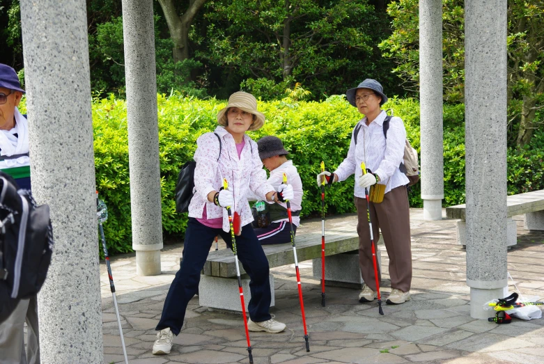 three people with walking poles standing in front of some pillars