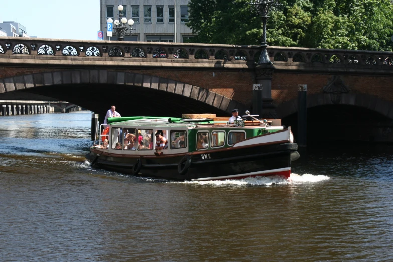 the people are on the boat in the river