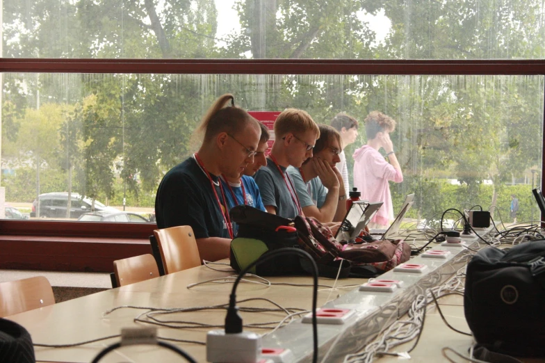 the group of people are sitting at the table