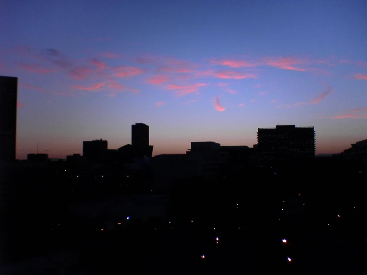 a sunset view over a city in the distance