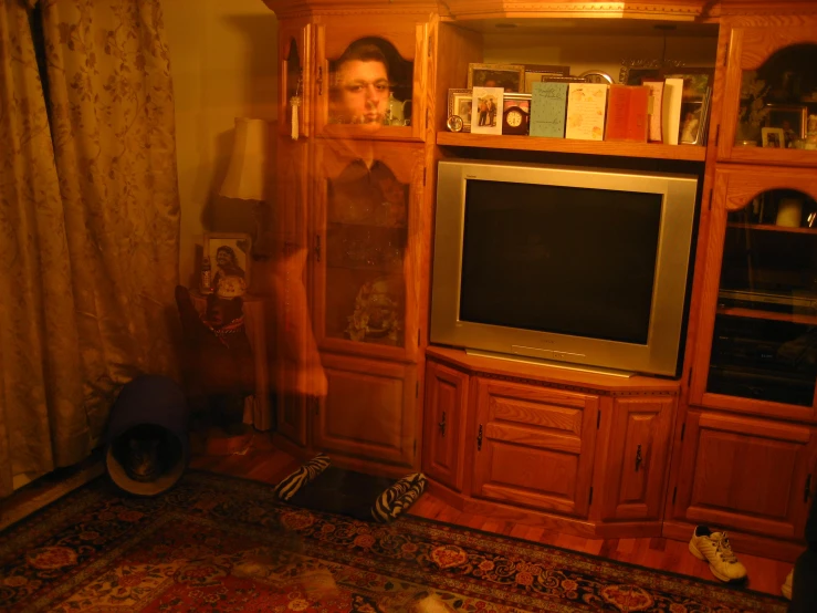 a girl is leaning against the cabinet with her feet up