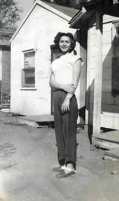 a black and white po of a woman in front of a building