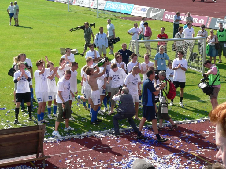 people on a soccer field celeting with a crowd