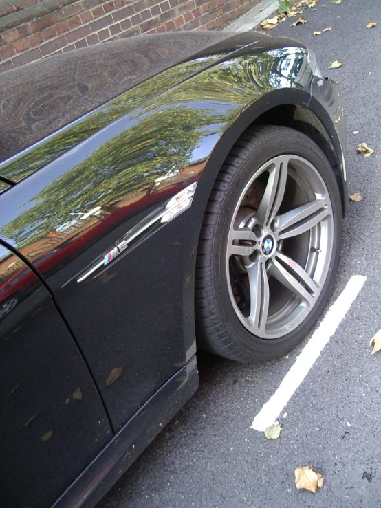 a bmw car with black exterior parked in the street