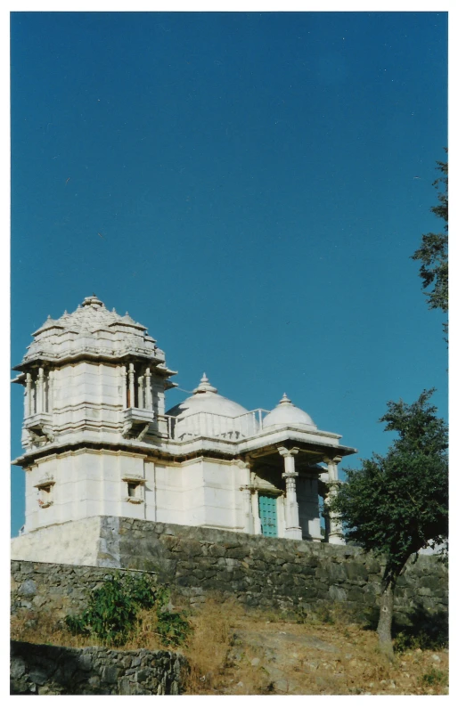 a view of a large white stone building with columns