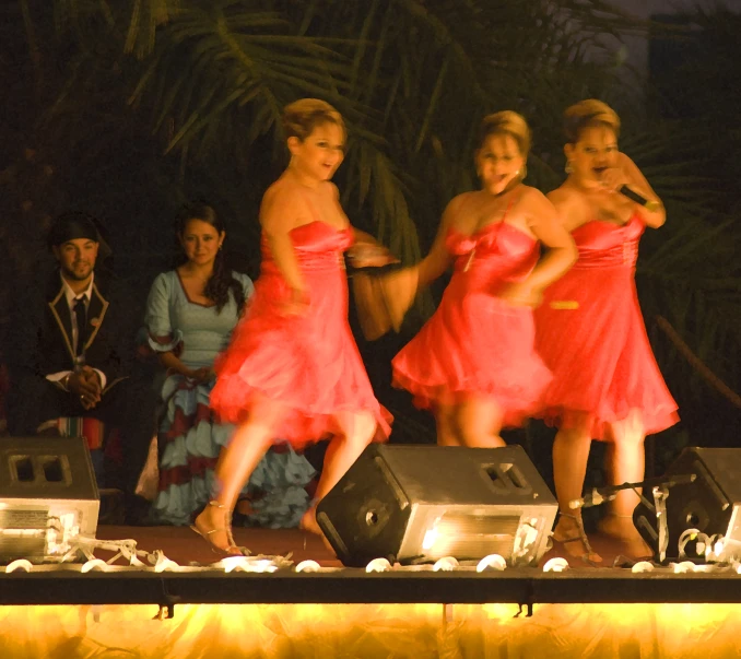 a group of girls are standing on stage