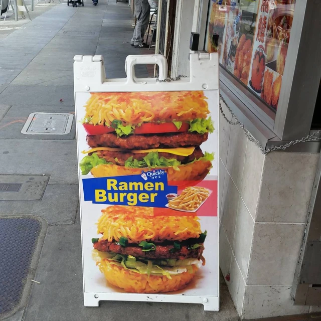 a large burger sits in front of a restaurant