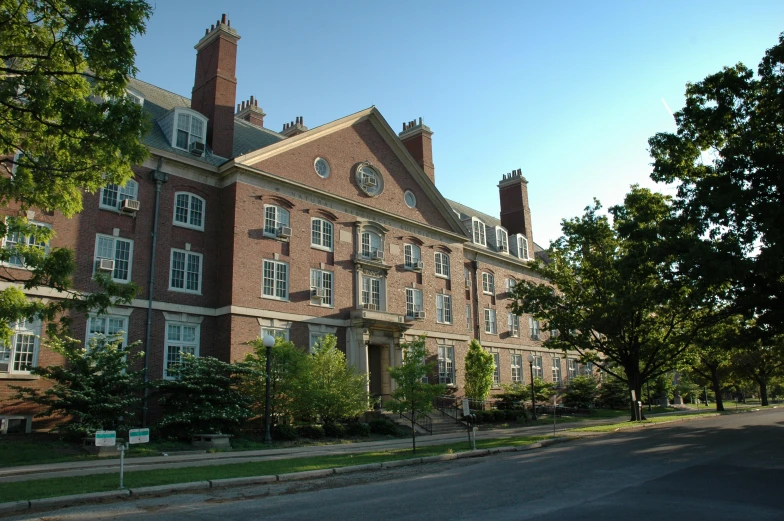 the building is a two story building with a dorm roof and clock