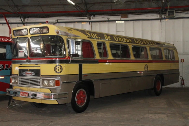 a bus sitting in a garage near another bus