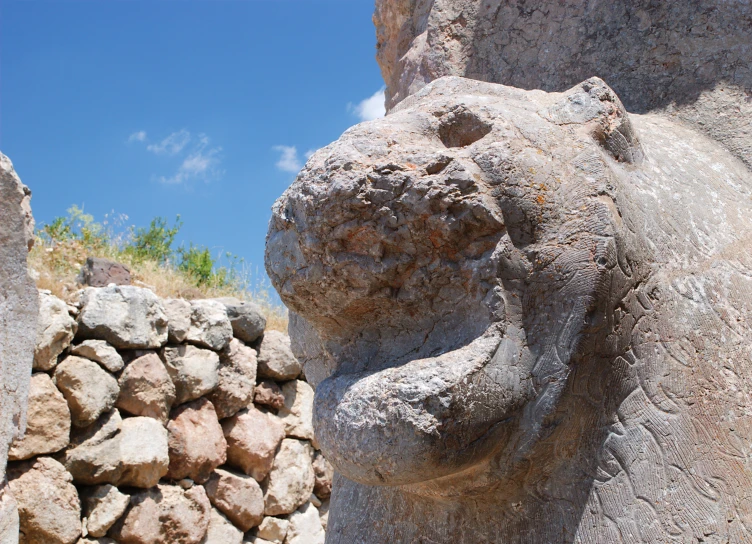 a statue of a elephant with its trunk up