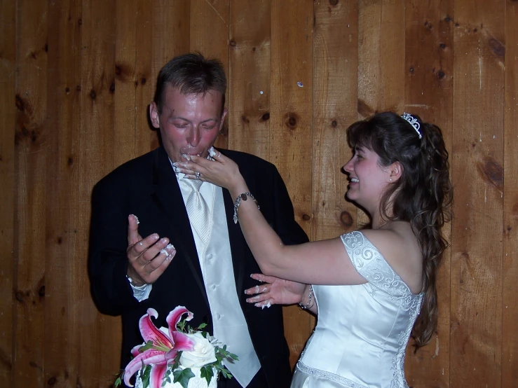 the man and woman are about to feed each other cake