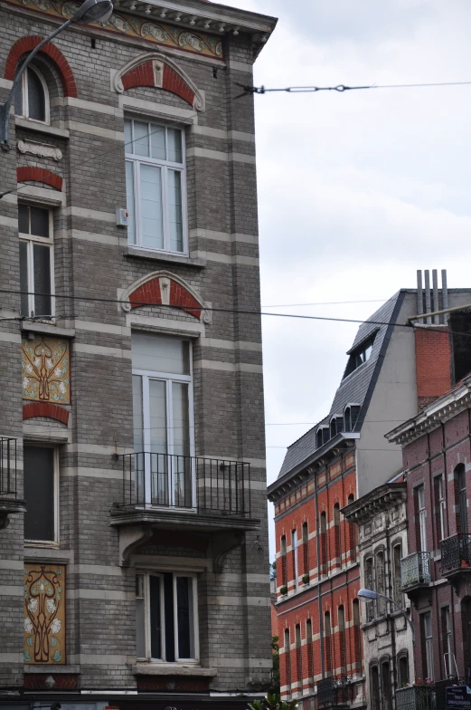 a tall brick building with a balcony and balconies