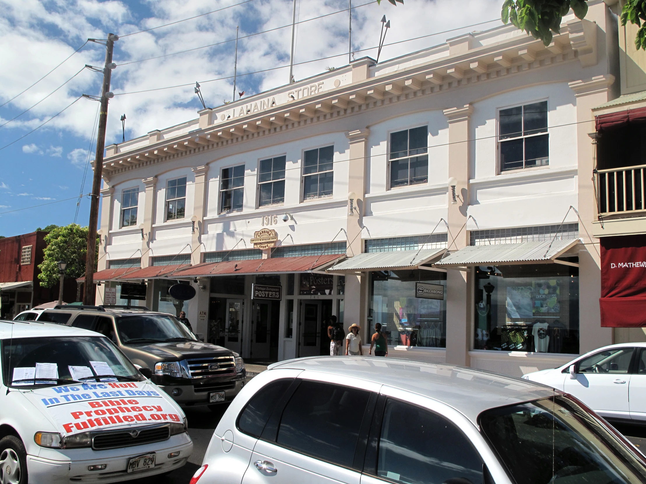 a white building sitting next to a sidewalk