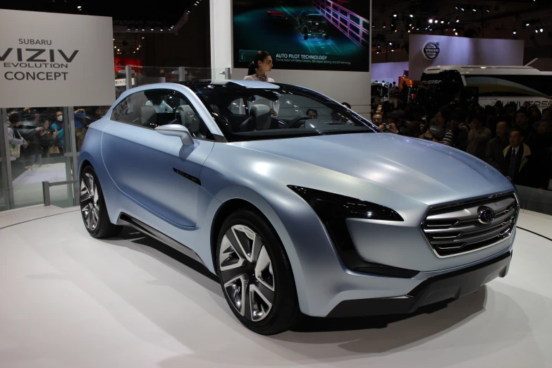 a futuristic car is displayed during a motor show