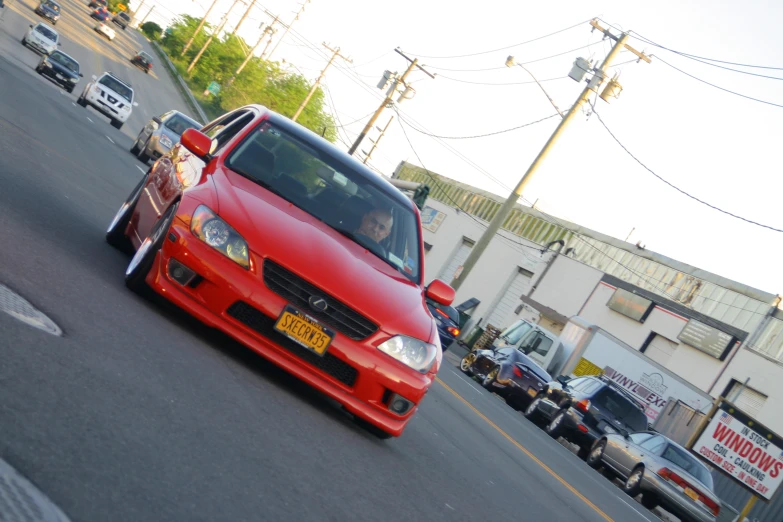 a red car parked in the middle of a street