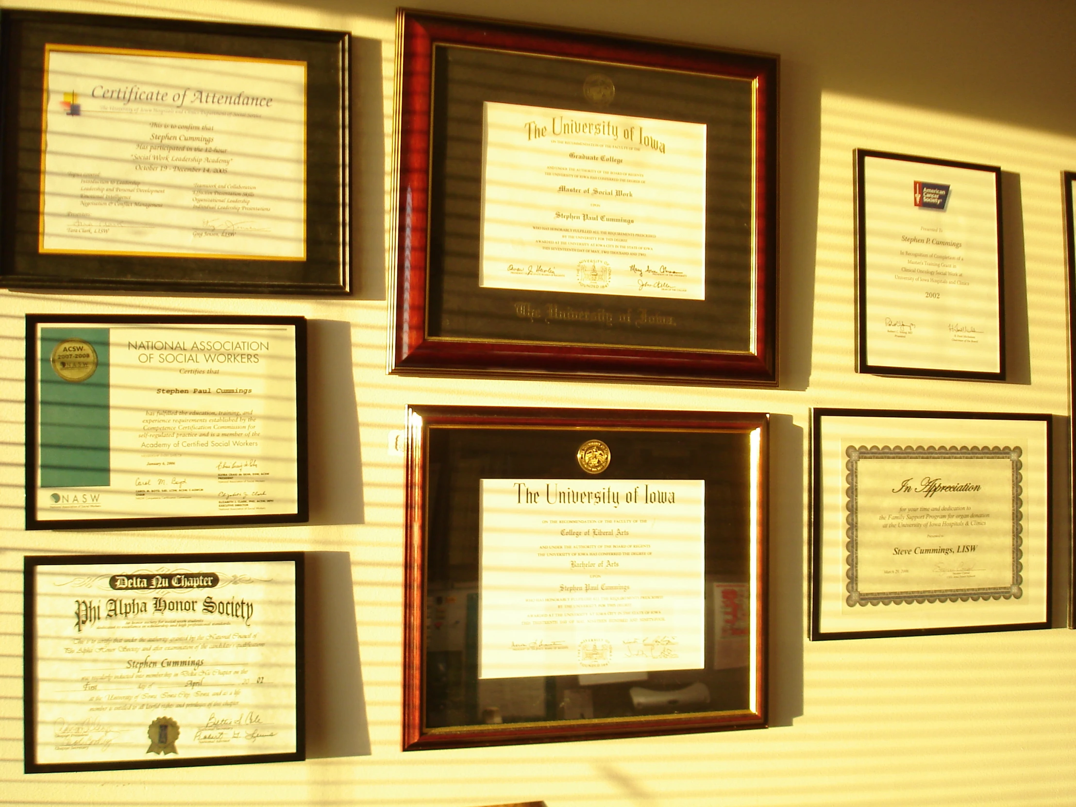 several plaques and frames on a wall that feature a menu