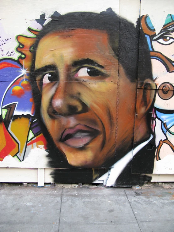 obama is pictured in front of an image of his head and shoulders