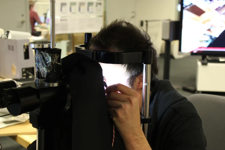 a man wearing blindfolds covering his eyes while taking a picture