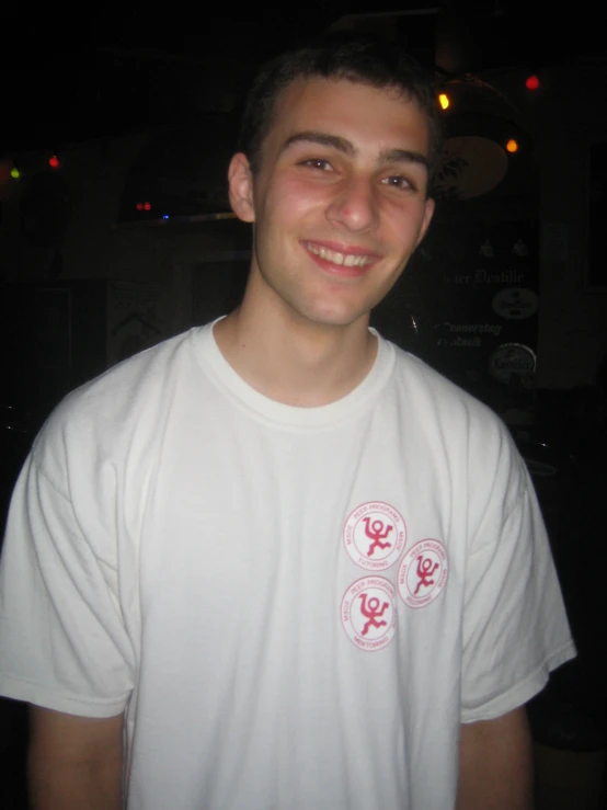 a man with a smile standing next to a building