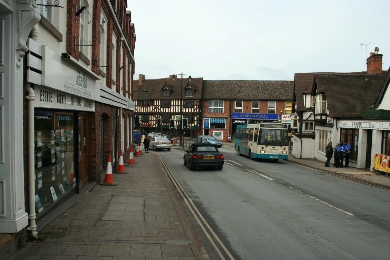 a car parked on the side of a road in front of a bus