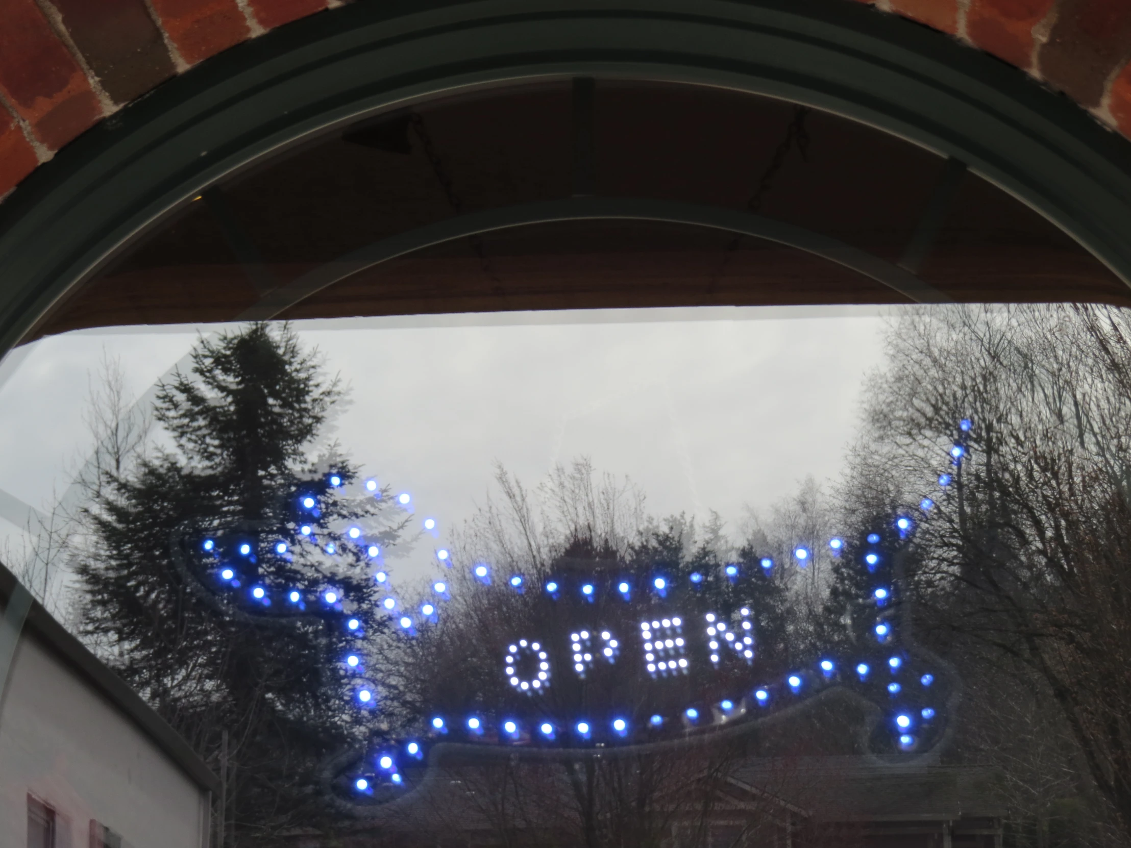 a sign saying open hanging out the side of a building