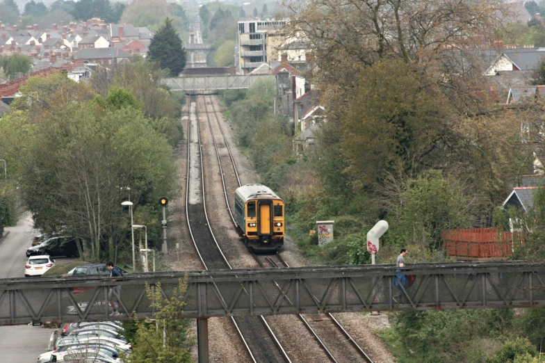 there is a train traveling on the railroad tracks