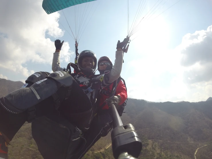 two people flying in the air with parachutes attached to their necks