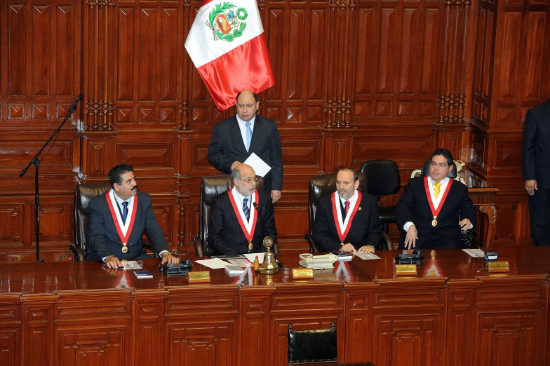 an official and officials during a meeting in a courtroom