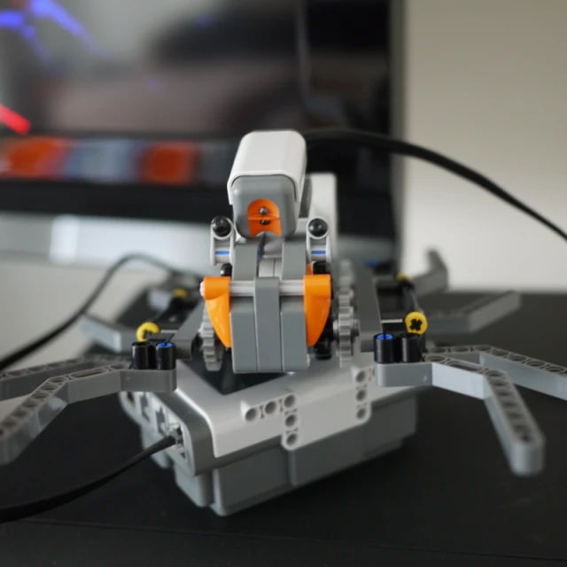 a robot made from lego parts sitting on top of a table