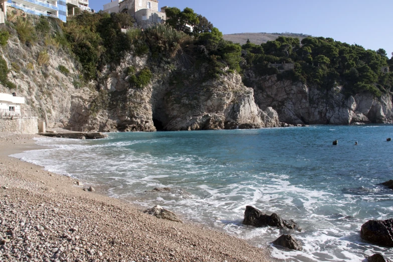 people are swimming in a clear body of water