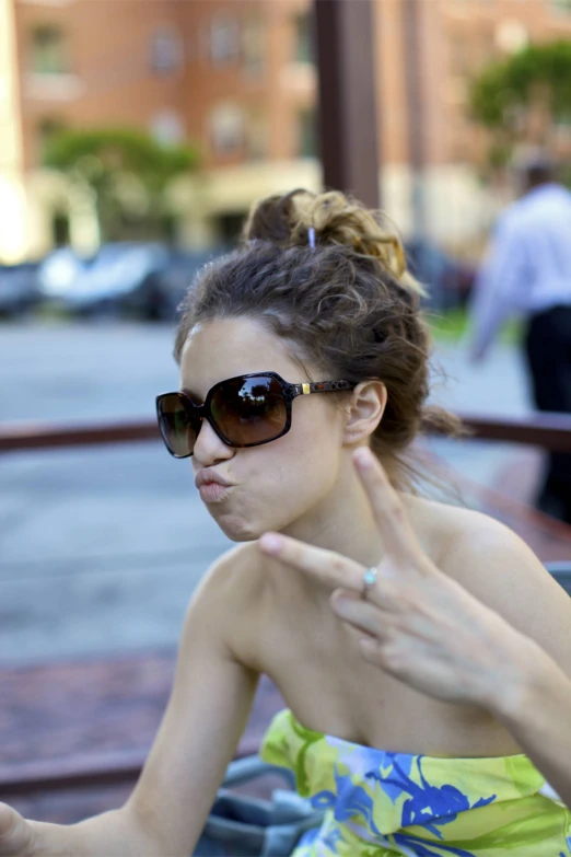 a woman in sunglasses talking on her cell phone