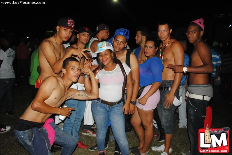 a group of people that are standing in the grass