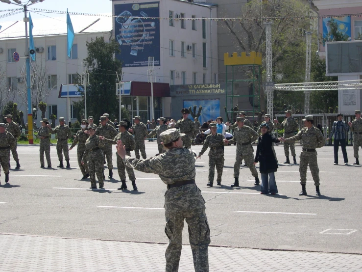 army men in camouflage military uniforms, standing on a street