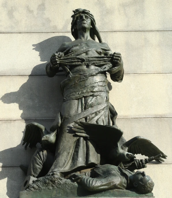 a statue of a woman holding an umbrella next to her hands