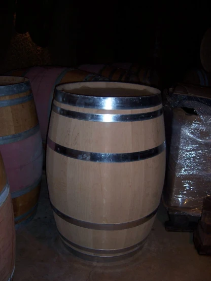 there are two wooden barrels sitting on the ground