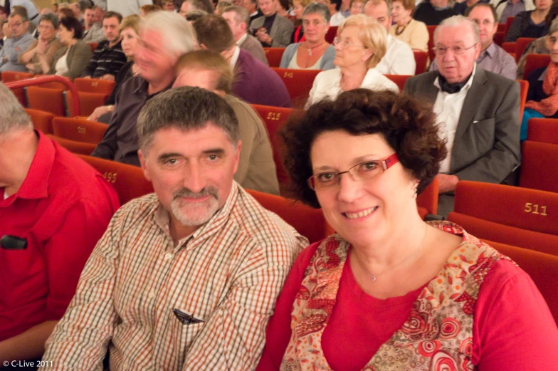 two people sitting in a stadium with spectators