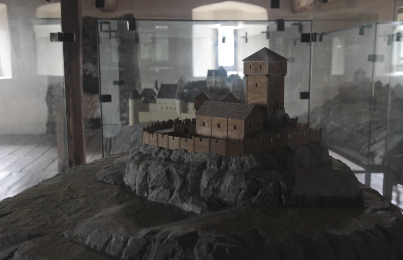 a model building sits on a piece of rock