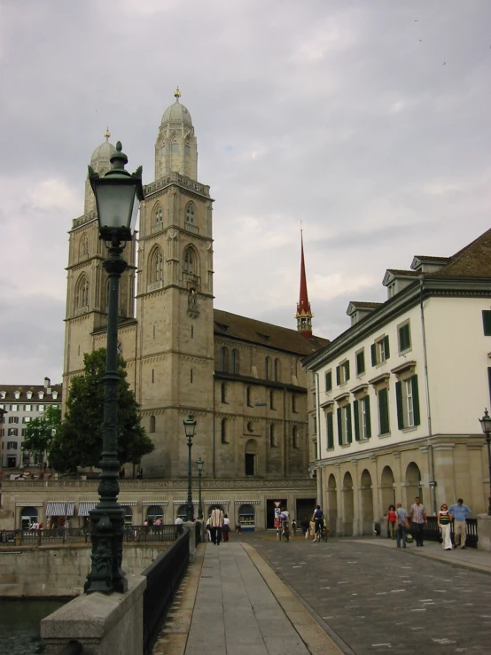 a tall building with many towers near water