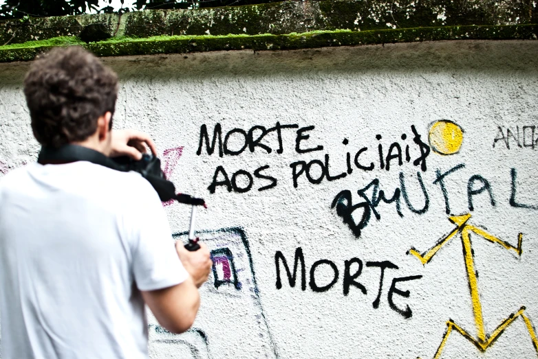 a man taking a pograph of graffiti on the wall